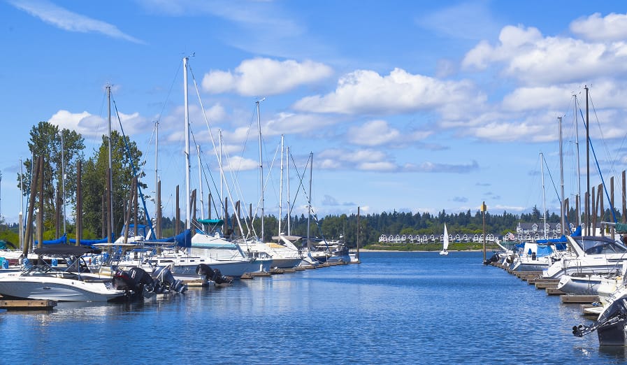 View of a dock row leading out to the main Channel of the Columbia river at Tomahawk Bay Marina on Hayden Island in Portland Oregon